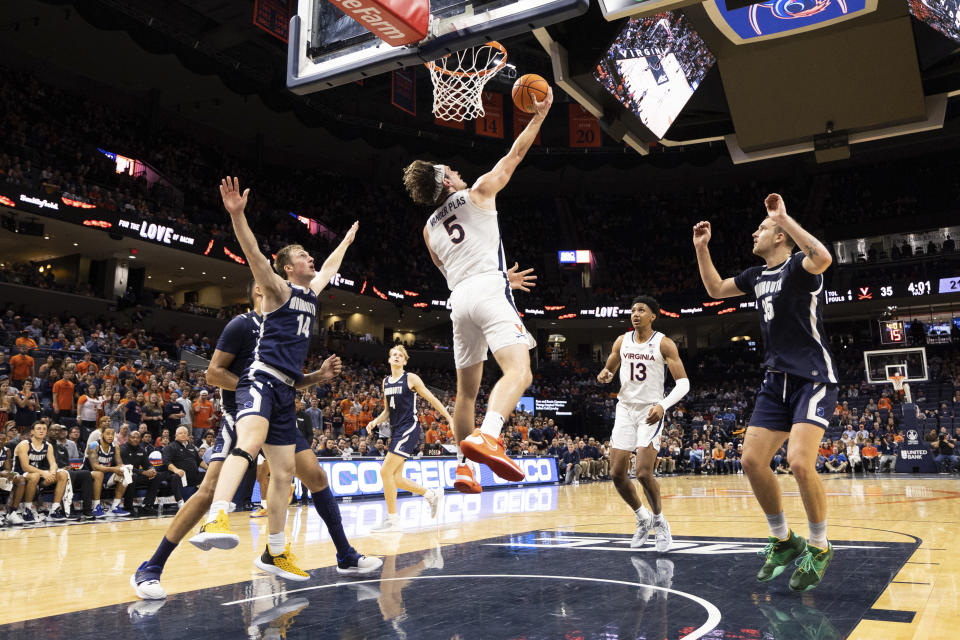 Virginia's Ben Vander Plas (5) makes a basket against Monmouth during the first half of an NCAA college basketball game in Charlottesville, Va., Friday, Nov. 11, 2022. (AP Photo/Mike Kropf)