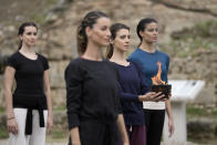 Actresses perform during the final rehearsal for the lighting of the Olympic flame at Ancient Olympia site, birthplace of the ancient Olympics in southwestern Greece, Sunday, Oct. 17, 2021. The flame will be transported by torch relay to Beijing, China, which will host the Feb. 4-20, 2022 Winter Olympics. (AP Photo/Petros Giannakouris)