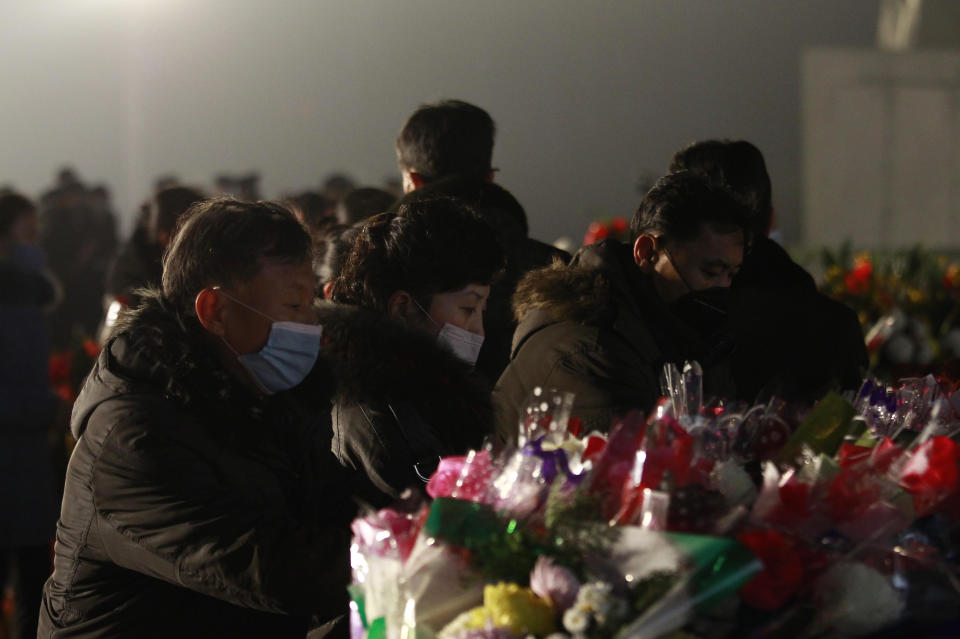 Citizens lay bouquets of flowers at the bronze statues of their late leaders Kim Il Sung and Kim Jong Il on Mansu Hill in Pyongyang, North Korea Thursday, Dec. 16, 2021, on the occasion of 10th anniversary of demise of Kim Jong Il. (AP Photo/Jon Chol Jin)