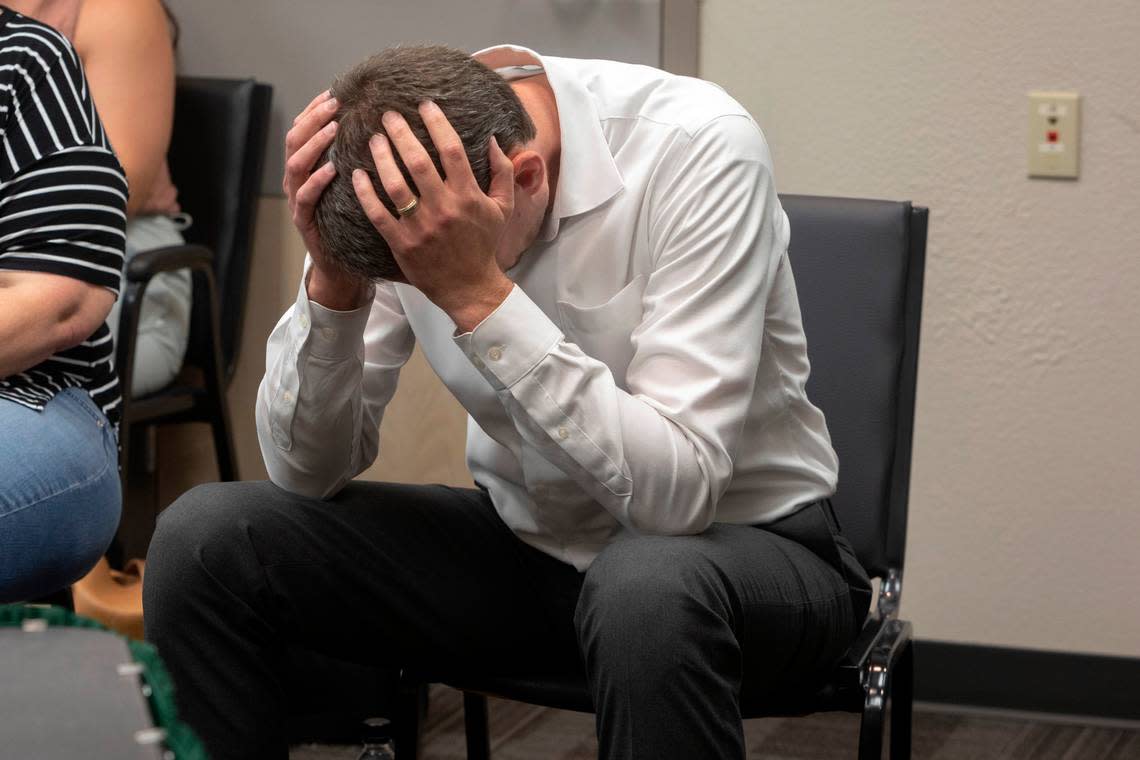 Chandler Crouch holds his head in his hands during an emergency board meeting at the Tarrant Appraisal District in Fort Worth, Texas, on Thursday, June 30, 2022. Crouch and supporters arrived to defend him against a complaint filed by a TAD director.