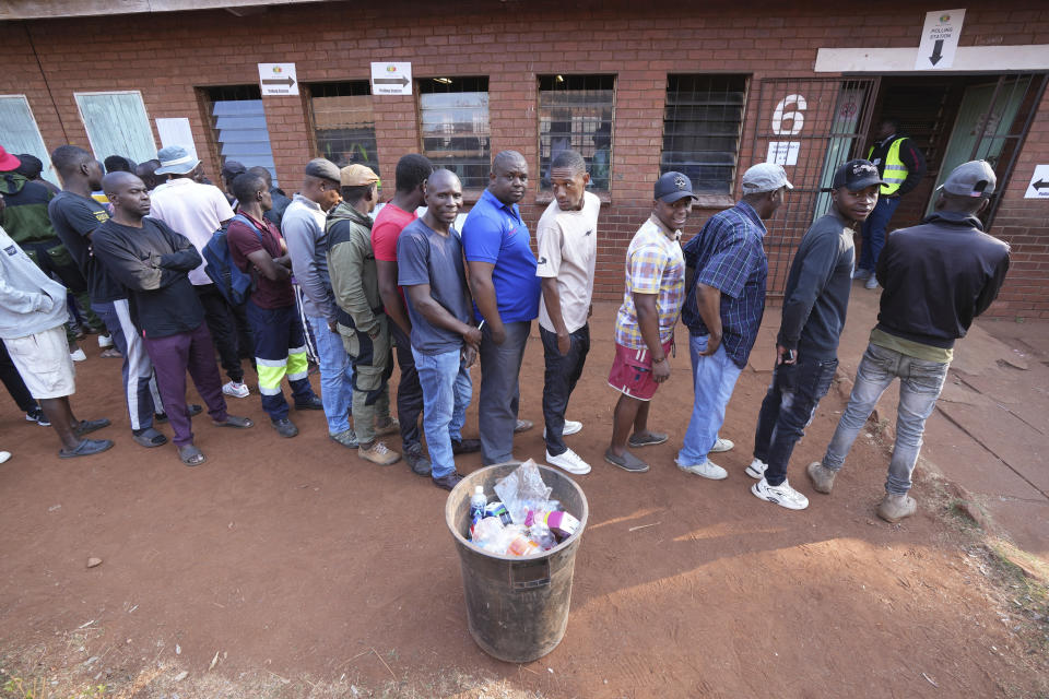 Voters wait in a queue to cast their votes at a polling station in Harare, Wednesday, Aug. 23 2023. Polls opened in Zimbabwe on Wednesday as President Emmerson Mnangagwa seeks a second and final term in a country with a history of violent and disputed votes. (AP Photo/Tsvangirayi Mukwazhi)