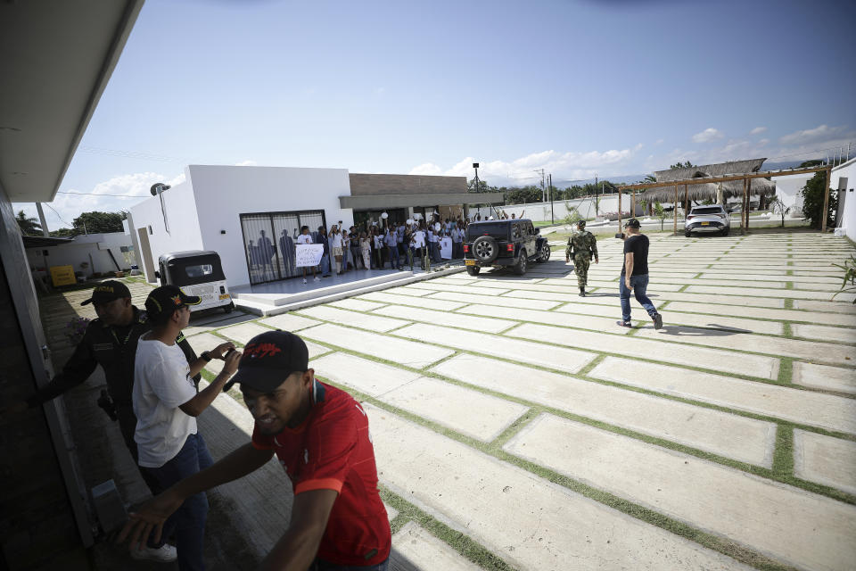 Neighbors of Luis Manuel Díaz wait for his arrival outside his home in Barrancas, Colombia, after he was released by his kidnappers, Thursday, Nov. 9, 2023. Díaz, the father of Liverpool striker Luis Díaz, was kidnapped on Oct. 28 by the guerrilla group National Liberation Army, or ELN. (AP Photo/Ivan Valencia)