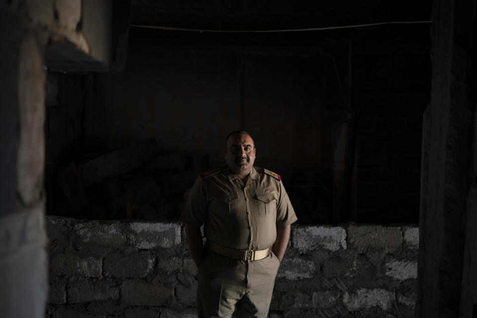 In this April 9, 2019 photo, Iraqi army 20th division Maj. Khalid Abdullah Baidar al-Jabouri poses for a portrait in Badoush, Iraq. His battalion is based in the area as a peacekeeping force, setting up checkpoints and carrying out raids to identify and arrest remaining Islamic State militants. "The operations that we do now rely on intelligence by following up the families of Daesh," he said, using the Arabic acronym for the group. (AP Photo/Felipe Dana)