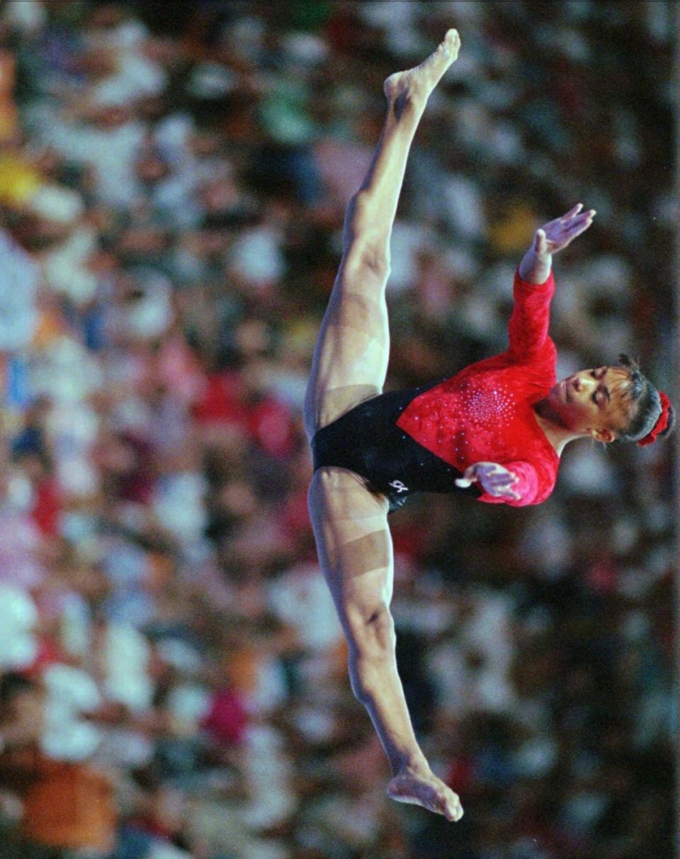 Dominique Dawes performs on the balance beam during the finals of the Coca-Cola National Gymnastics Championships Saturday, June 8, 1996 in Knoxville, Tenn.. Dawes scored a 9.862 on the beam to win that event.