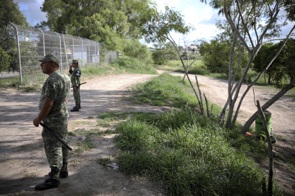 Military police wearing the insignia of the National Guard patrol near the border bridge that crosses the Rio Grande river in Matamoros, Mexico, Thursday, Aug. 1, 2019, on the border with Brownsville, Texas. Migrants are being sent back to wait in this Mexican state of Tamaulipas, a place the U.S. State Department warns Americans to avoid all travel due to high levels of violence and kidnapping, under a plan known colloquially as “remain in Mexico.” (AP Photo/Emilio Espejel)