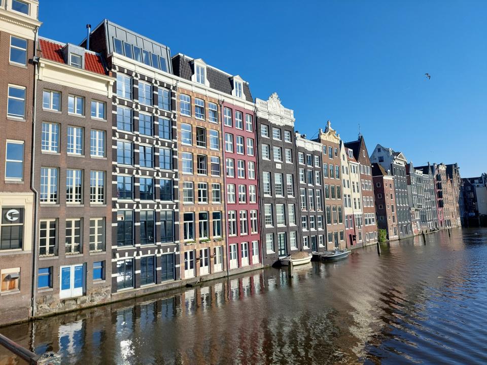A row of terraced houses in Amsterdam along a canal