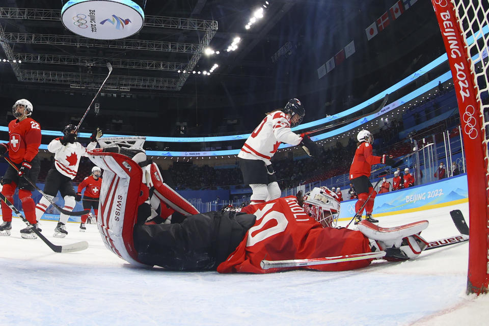 Canada's Blayre Turnbull (40) celebrates after scoring against Switzerland goalkeeper Andrea Braendli (20) during a women's semifinal hockey game at the 2022 Winter Olympics, Monday, Feb. 14, 2022, in Beijing. (Jonathan Ernst/Pool Photo via AP)