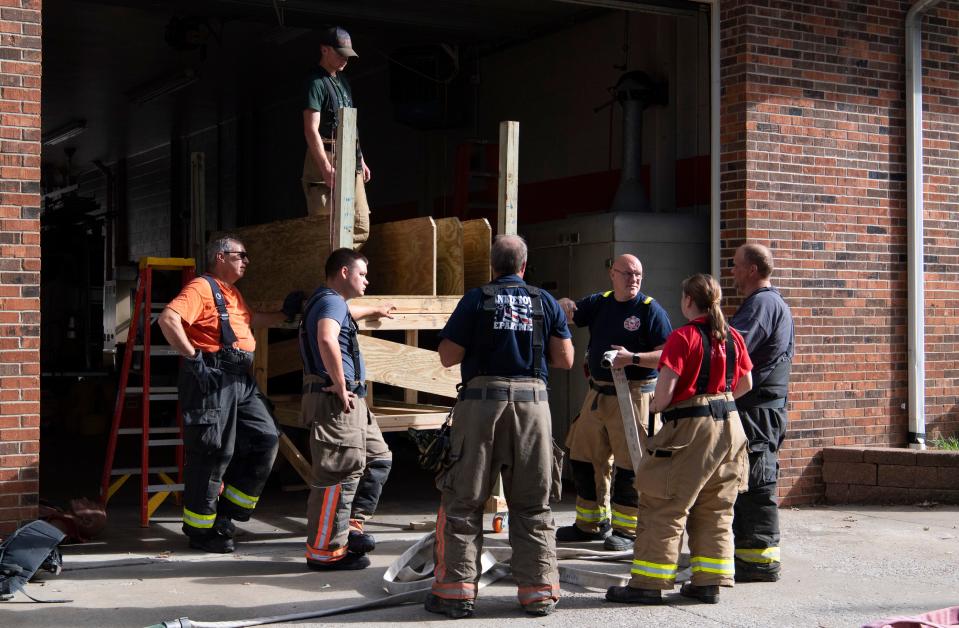 Newburgh Volunteer Fire Department Captain Courtney Marx, center, discusses different line options during a training session Saturday, Sept. 16, 2023.