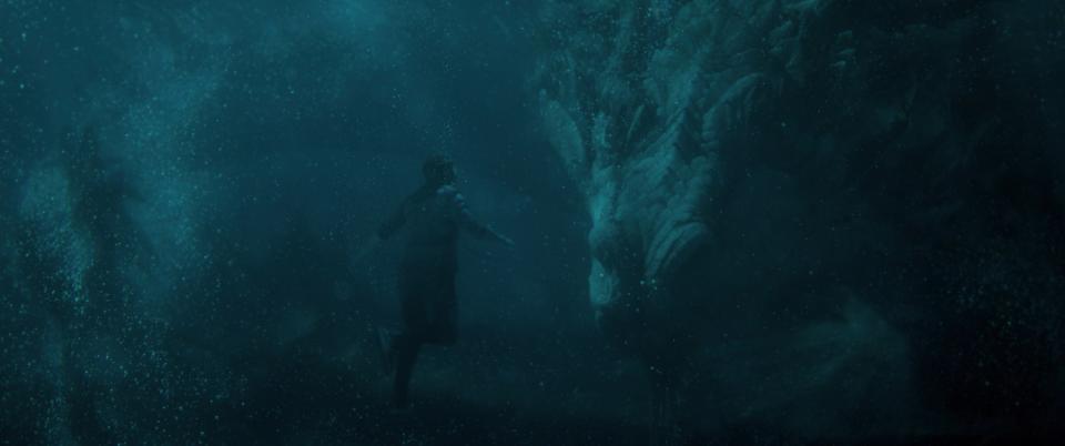 A man swims with a dragon underwater