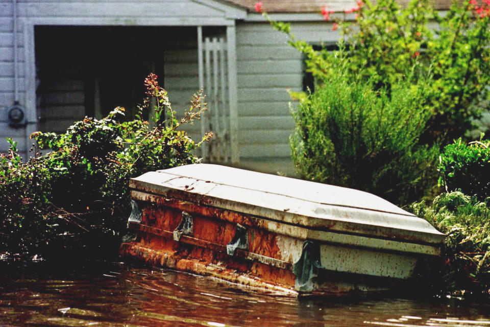 FILE - A casket floats in a flooded yard in Princeville, N.C., Sept. 22, 1999, in the aftermath of Hurricane Floyd. Historic Princeville, on the banks of the Tar River in eastern North Carolina, is one hurricane away from disaster. Two hurricanes 17 years apart created catastrophic flooding in the town, which was built on swampy land. (Steve Earley/The Virginian-Pilot via AP)