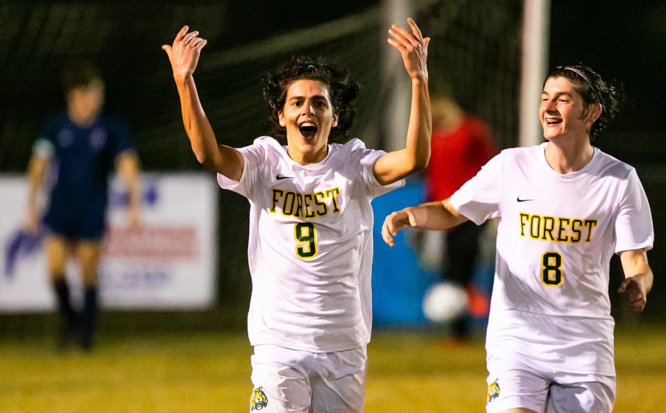 Forest's Edwin Abreu (9) celebrates his second goal Friday with teammate Brantley Wigginton (8). The score made it 3-1 Forest en route to a win over Vanguard at Booster Stadium.