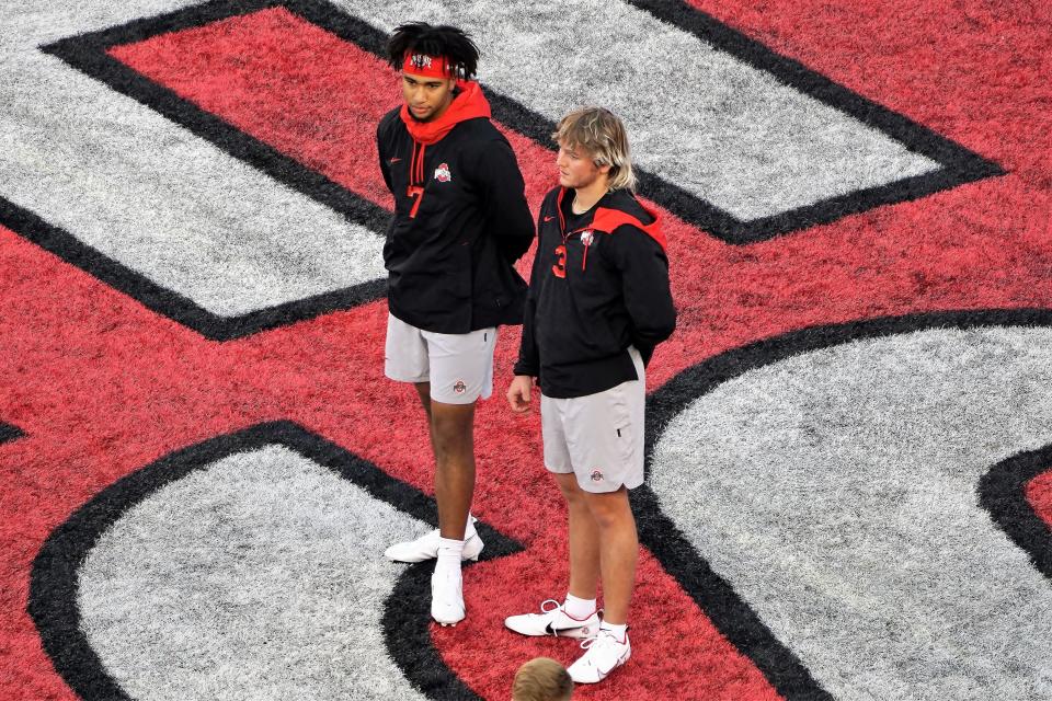 C.J. Stroud (left) and Quinn Ewers watch Ohio State warm up.