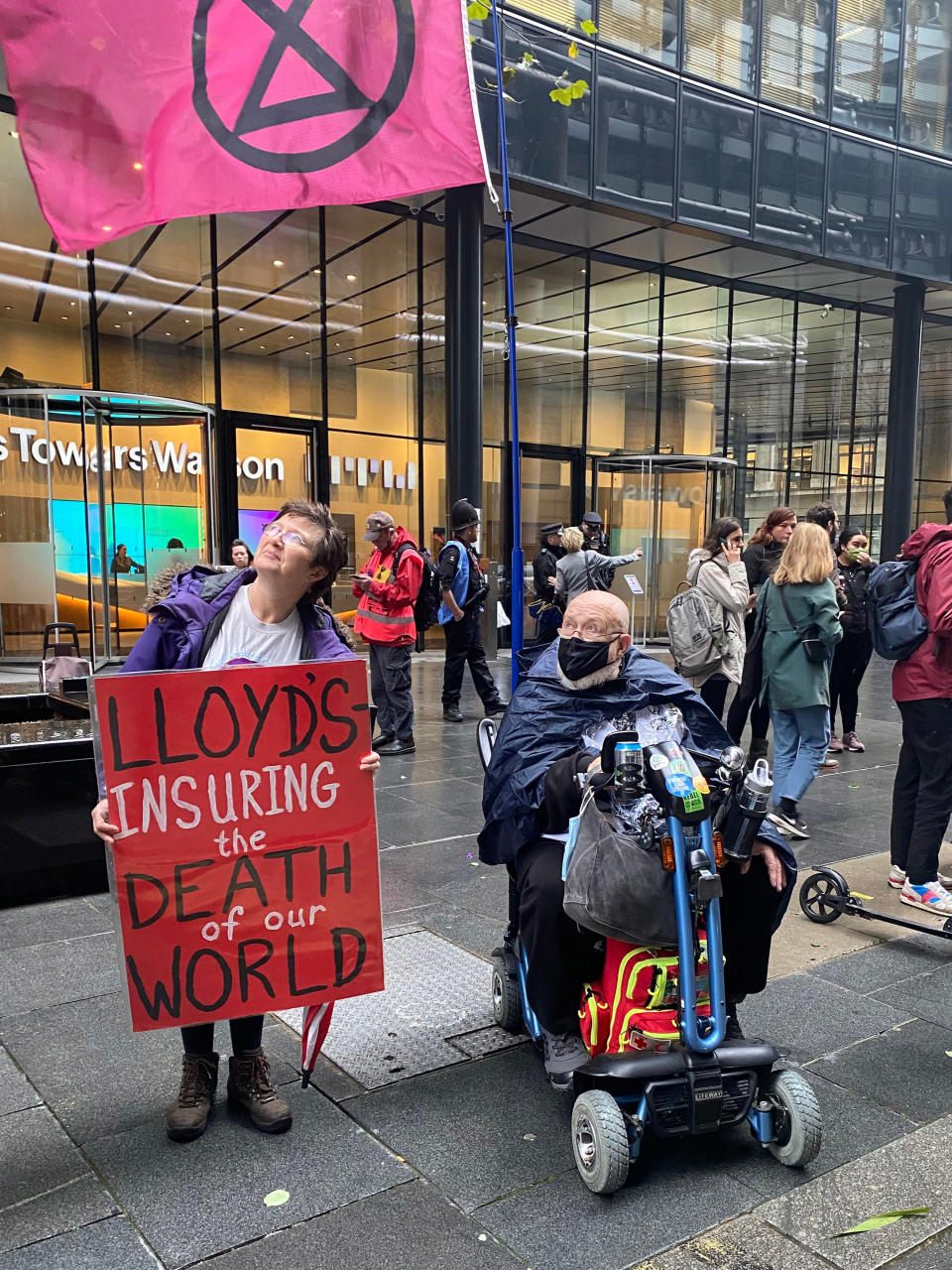 Protesters outside Lloyds of London to demand the global financial system stops putting money into the use of fossil fuels (PA)