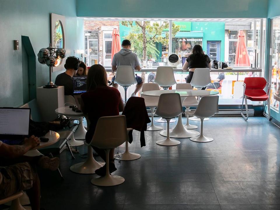  People using laptops at a coffee shop in Montreal.