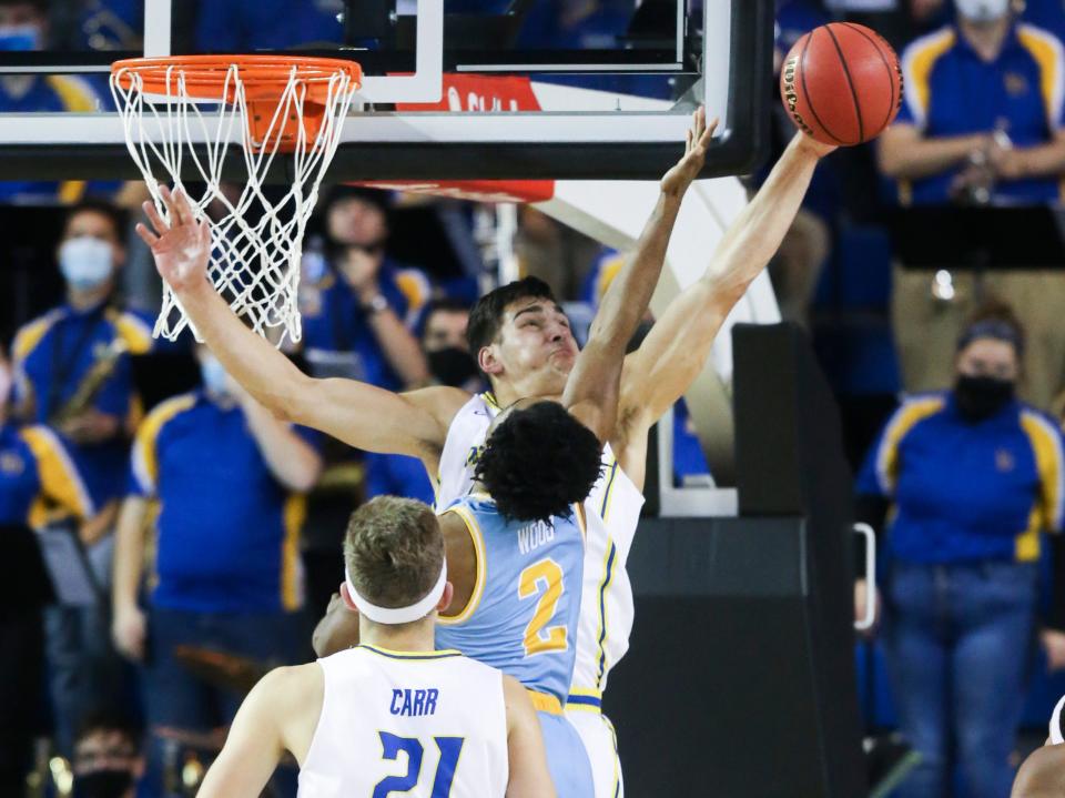 Delaware forward Dylan Painter blocks a shot by LIU's Tre Wood in the second half of Delaware's 75-67 win at the Bob Carpenter Center, Tuesday, Nov. 30, 2021.