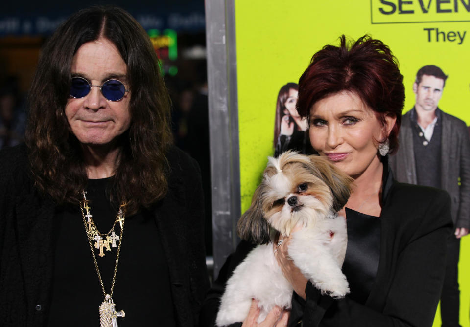 Ozzy Osbourne, left, and Sharon Osbourne, right pose with Bonny the dog at the premiere of "Seven Psychopaths" at the Bruin Theatre on Monday, Oct. 1, 2012 in Los Angeles. (Photo by Matt Sayles/Invision/AP)