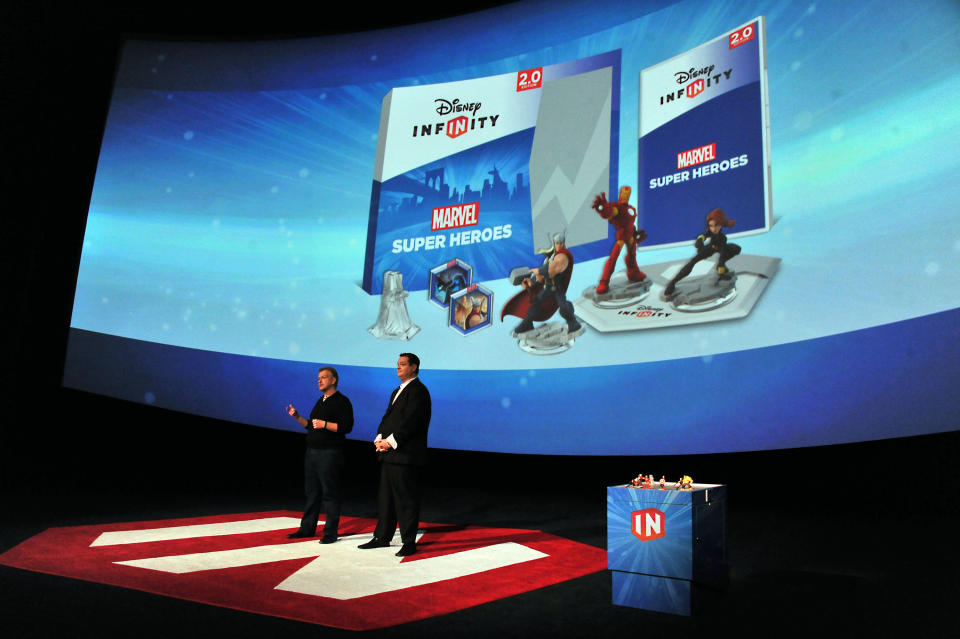 John Blackburn, left, and John Vignocchi speak at the Disney Infinity 2.0 launch held at Pacific Theatres Cinerama Dome on Wednesday, April 30, 2014 in Hollywood section of Los Angeles. (Photo by Katy Winn/Invision/AP)