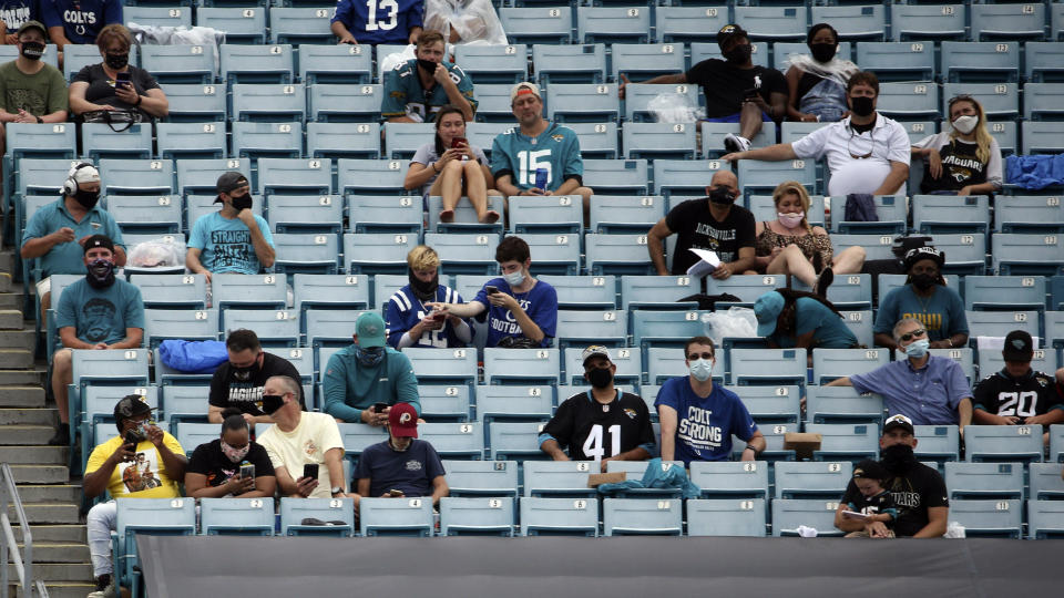 Fans are seated apart for social distancing during the first half of an NFL football game between the Jacksonville Jaguars and the Indianapolis Colts, Sunday, Sept. 13, 2020, in Jacksonville, Fla. (AP Photo/Stephen B. Morton)