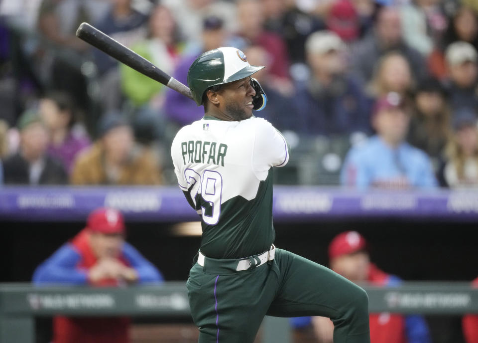 Colorado Rockies' Jurickson Profar watches his double off Philadelphia Phillies starting pitcher Ranger Suarez during the fourth inning of a baseball game Saturday, May 13, 2023, in Denver. (AP Photo/David Zalubowski)