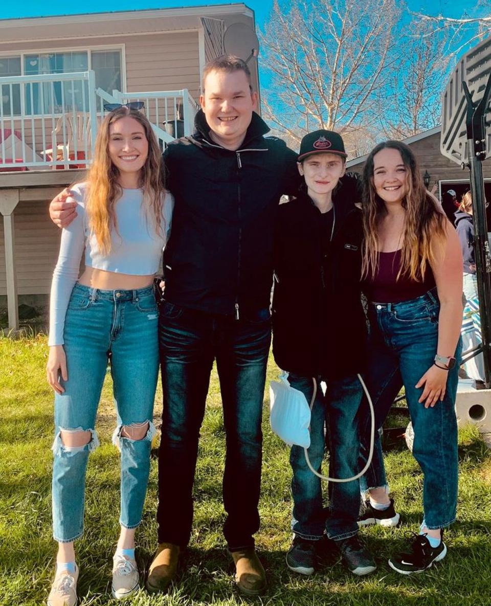 Eric Coulam, centre, poses with his friends at the celebration of life held at his father’s home in Fort St John, BC on 21 May (Facebook/Eric’s Army)