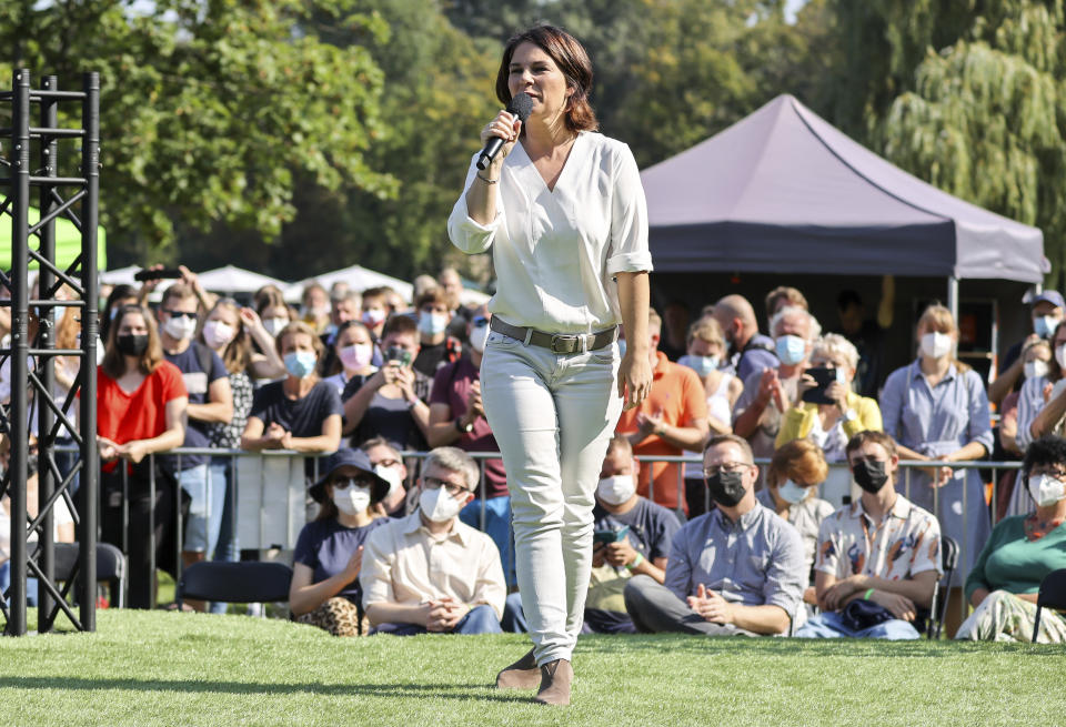 The candidate for chancellor of the German Green party, Annalena Baerbock, speaks during an election campaign event in Halle near Leipzig, Germany, Wednesday, Sept. 8, 2021. Climate change is among the top concerns for Germans going into this year's national election that will determine who replaces Angela Merkel as Chancellor. But while voters admit they are worried about the state of the planet, especially after last the deadly floods that hit Germany in July, many fear the cost of backing the environmentalist Green party that's campaigned strongest for meeting the Paris climate accord's goals. (Jan Woitas/dpa via AP)