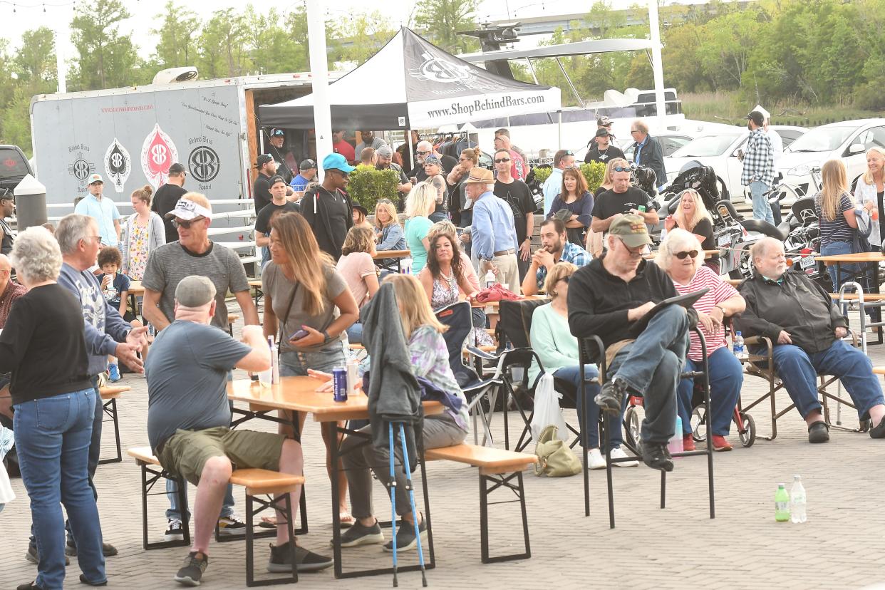 Guests listen along the Cape Fear River as Machine Gun performs Saturday, April 16, 2022 at the Boatyard at Marina Grill to kick off The Marina Grill's Saturday Sunset music series The series will continue most Friday evenings into the fall from 6-9 p.m. Saturdays and is free.