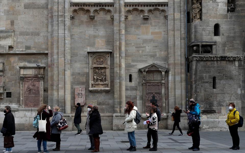 Austrians lining up to get a jab in Vienna on Friday - AP