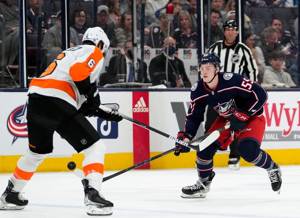 Columbus Blue Jackets right wing Carson Meyer (55) passes the puck up ice against Philadelphia Flyers defenseman Travis Sanheim (6) during the 1st period of their NHL game at Nationwide Arena in Columbus, Ohio on April 7, 2022.  