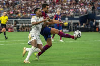 Real Madrid forward Rodrygo Silva, left, battles for the ball with FC Barcelona's Eric Garcia, right, during a Champions Tour soccer match, Saturday, July 29, 2023 at AT&T Stadium in Arlington, Texas. The European Union’s top court has ruled UEFA and FIFA acted contrary to EU competition law by blocking plans for the breakaway Super League. The case was heard last year at the Court of Justice after Super League failed at launch in April 2021. UEFA President Aleksander Ceferin called the club leaders “snakes” and “liars.” (AP Photo/Jeffrey McWhorter)