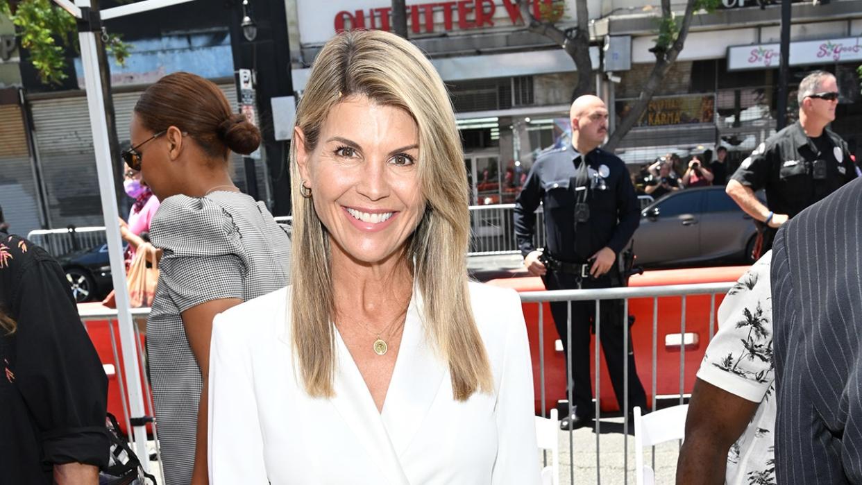 Lori Loughlin smiling on a public street