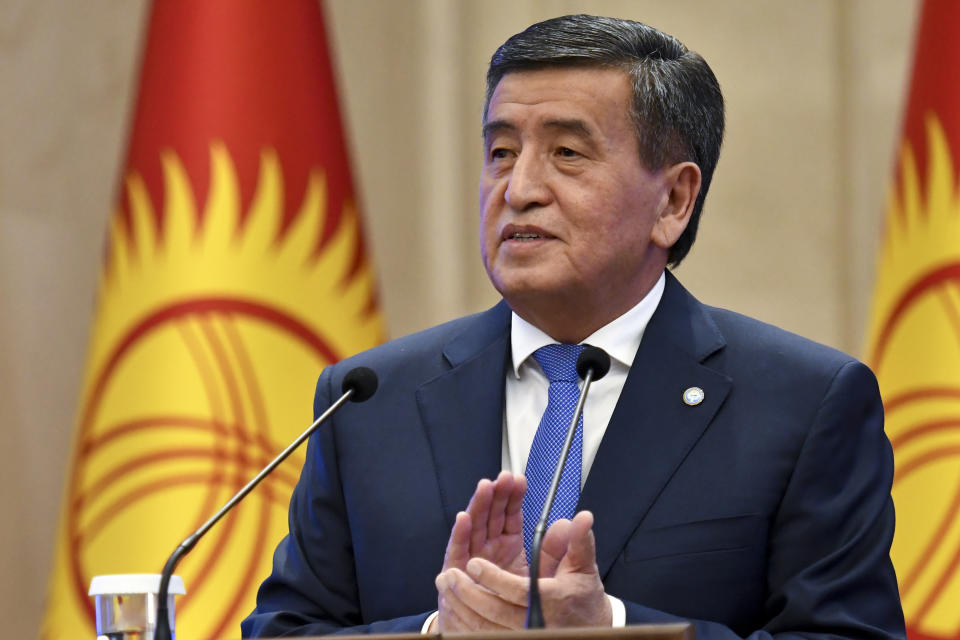 Kyrgyzstan's President Sooronbai Jeenbekov applauds after delivering his speech during an official ceremony of transfer of the power at the Kyrgyzstan Parliament in Bishkek, Kyrgyzstan, Friday, Oct. 16, 2020. Kyrgyzstan's embattled president has his resignation after a disputed parliamentary election in the Central Asian nation. It's the third time in 15 years that a leader of the country has been ousted by a popular uprising. (AP Photo/Vladimir Voronin)