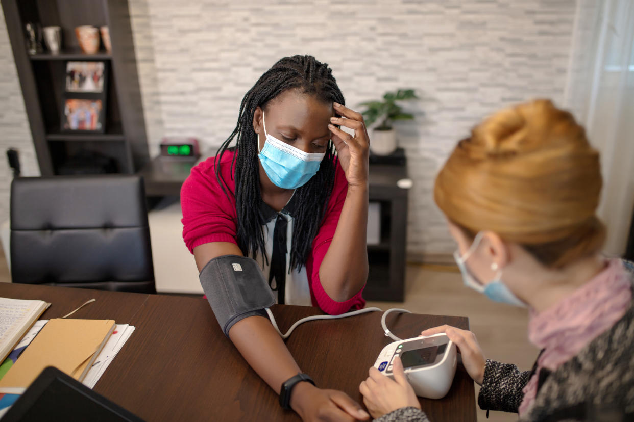 Doctor seeing patient in mask