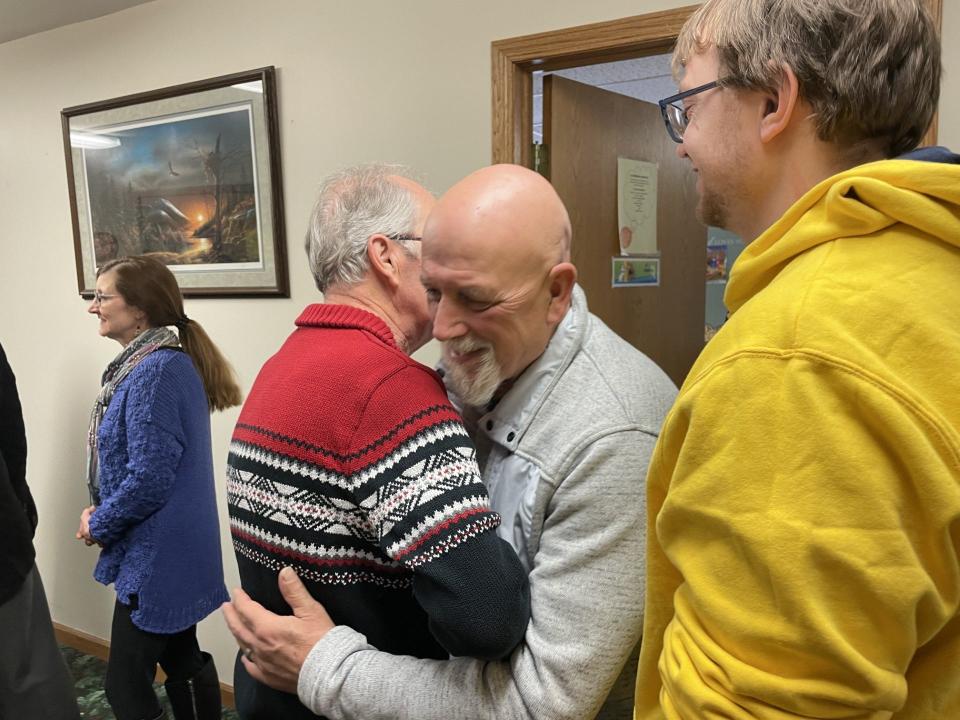 Pastor Louie Barnett, retired pastor of Bethany Eagle’s Nest Community Church, hugs an attendee at Sunday's retirement reception.