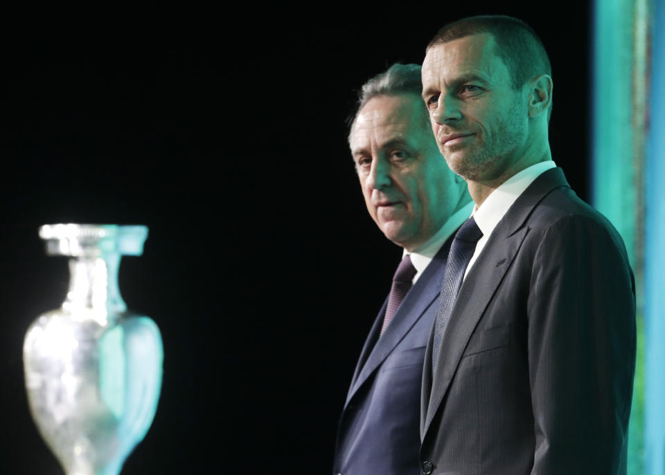 FILE - UEFA President Aleksander Ceferin, foreground, and Vitaly Mutko, Russia's deputy prime minister in charge of sport, tourism and youth policies attend the launch ceremony of a logo for the Euro 2020 soccer championship in St.Petersburg, Russia, Thursday, Jan. 19, 2016. In recent years, UEFA and its president Aleksander Ceferin were praised for blocking projects — a $25 billion deal for new global competitions, biennial World Cup, a European Super League — either pushed by FIFA or discreetly supported by its president Gianni Infantino. UEFA values are being questioned on issues where FIFA has publicly stood firm: Russia and ousted Spanish soccer official Luis Rubiales. (AP Photo/Dmitri Lovetsky)