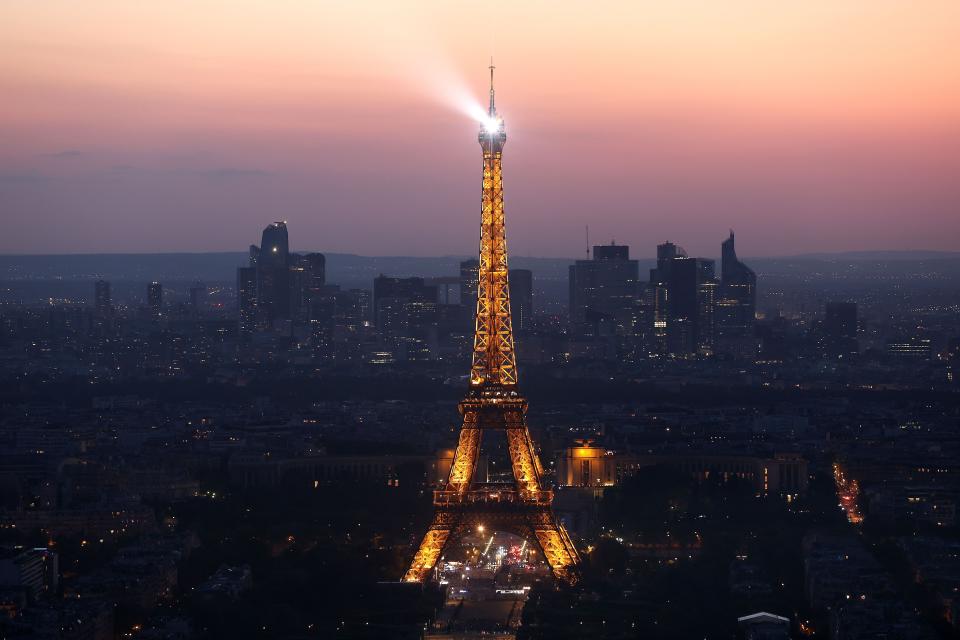 The Eiffel Tower stands illuminated after sunset on July 07, 2023 in Paris, France. Paris will host the Summer Olympics from July 26 till August 11, 2024.