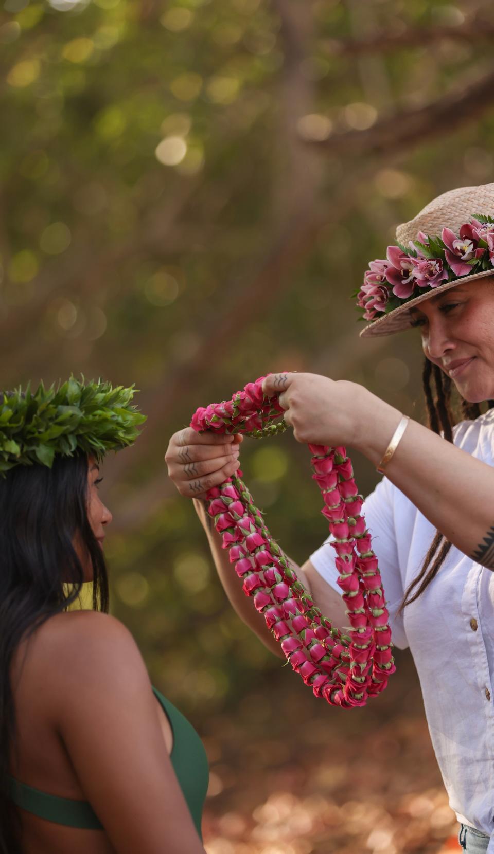 Native Hawaiian Britney Texeira offers a lei made of Maui's flower.