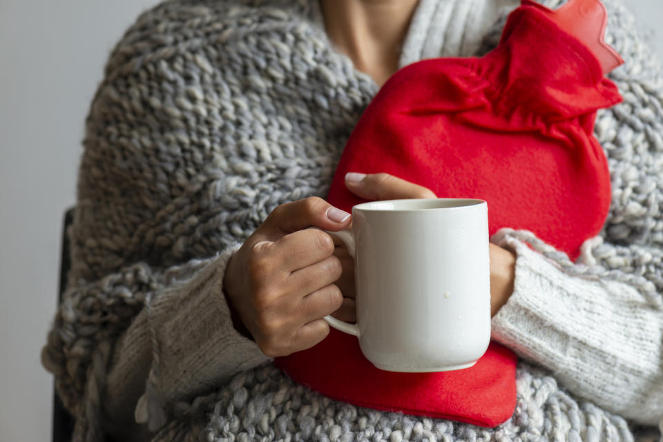 Stock picture of a woman keeping warm with a hot water bottle. (Getty Images)