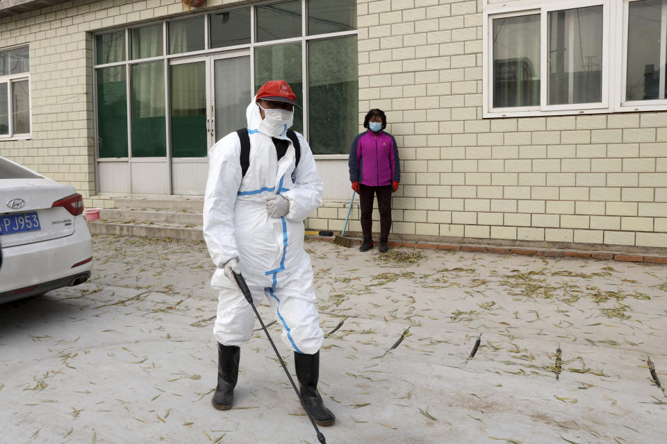 A worker sprays disinfectant near a sealed off pig farm after the latest incident of African swine flu outbreak on the outskirts of Beijing, China, Friday, Nov. 23, 2018. Reeling from rising feed costs in Beijing's tariff fight with U.S. President Donald Trump, Chinese pig farmers face a new blow from an outbreak of African swine fever that has sent an economic shockwave through the countryside. (AP Photo/Ng Han Guan)