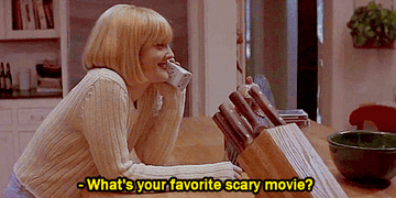 A woman on the phone being asked "What's your favorite scary movie?"