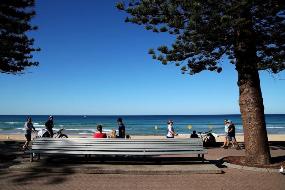 People observe social distancing guidelines at Manly Beach. Source: Getty 