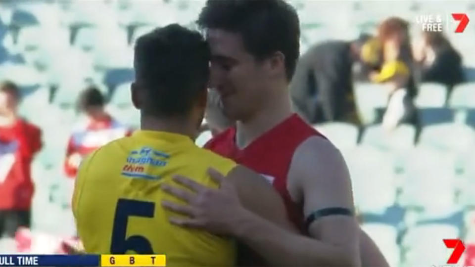 A North Adelaide player comforts an Eagles player after the preliminary final. Pic: Seven