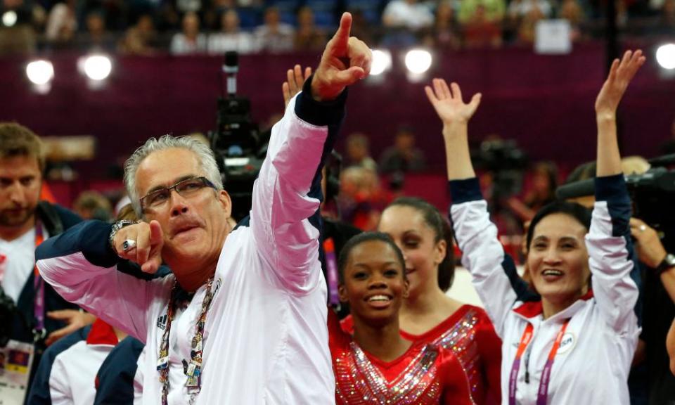 US women gymnastics team’s coach John Geddert celebrates with the rest of the team after the US won gold in the women’s team artistic gymnastics event at the London Olympic Games, 31 July 2012.