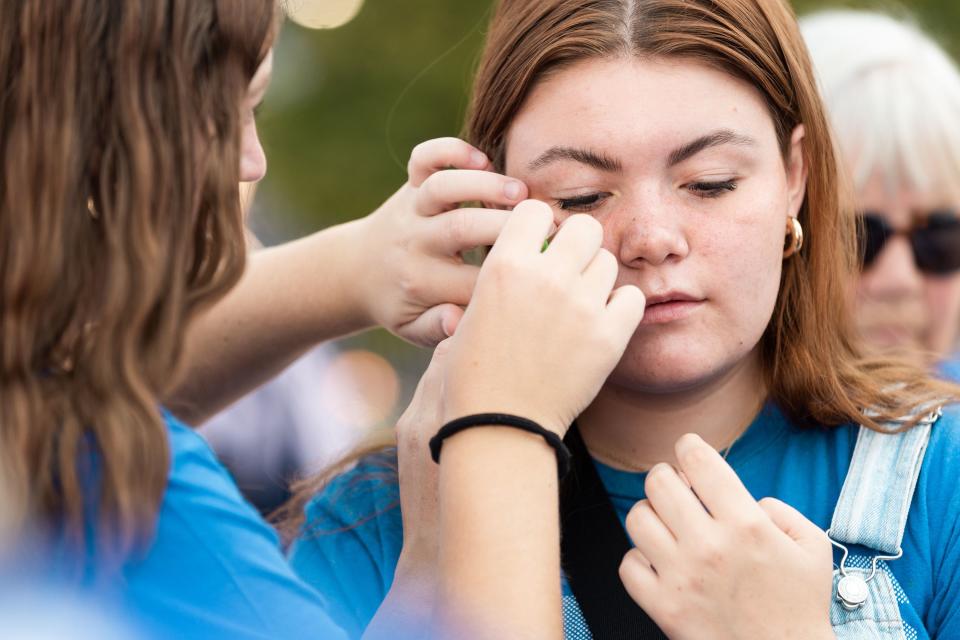 Left to right, Annie Idiart helps Abby Gibbons, both freshman at Brigham Young University, apply a temporary tattoo before the game against Southern Utah University at LaVell Edwards Stadium in Provo on Saturday, Sept. 9, 2023. | Megan Nielsen, Deseret News