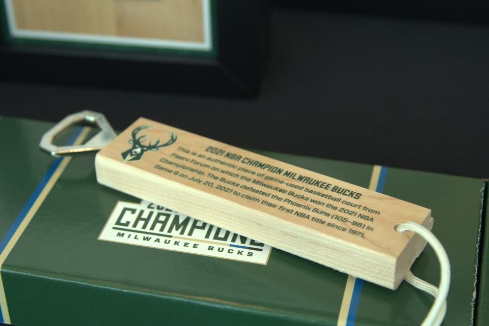 Items for sale include iconic-moments limited edition prints, decorative prints, and even bottle openers made of the 2021 NBA Championship Court from Fiserv Forum.