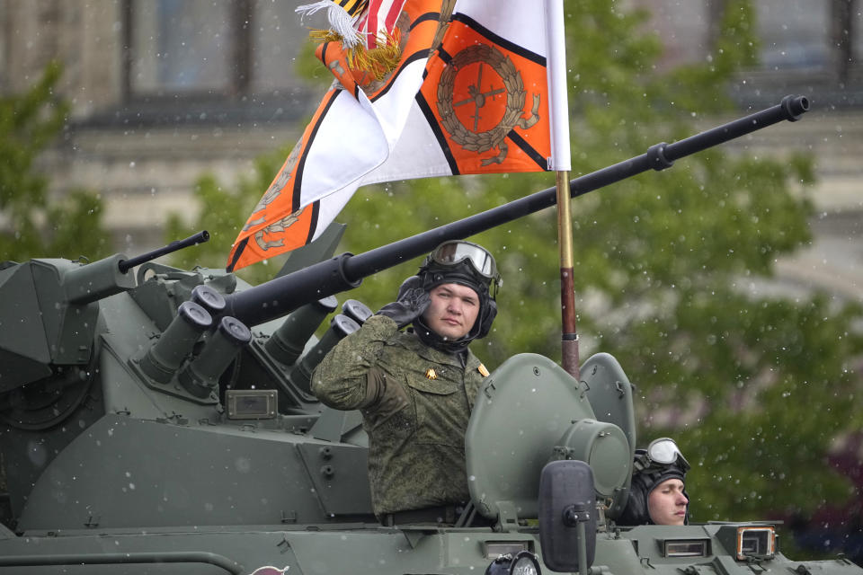 A Russian serviceman stands in a military vehicle rolling during the Victory Day military parade in Moscow, Russia, Thursday, May 9, 2024, marking the 79th anniversary of the end of World War II. (AP Photo/Alexander Zemlianichenko)