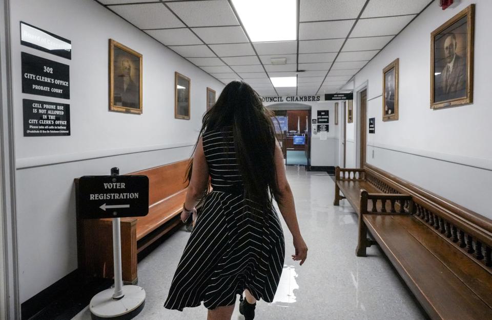 Sandra Perez heads down a hallway at Pawtucket's Municipal Court, where she serves as an interpreter. She does not have a professional credential, but she interpreted in state court when she worked as a paralegal before joining the mayor's office.