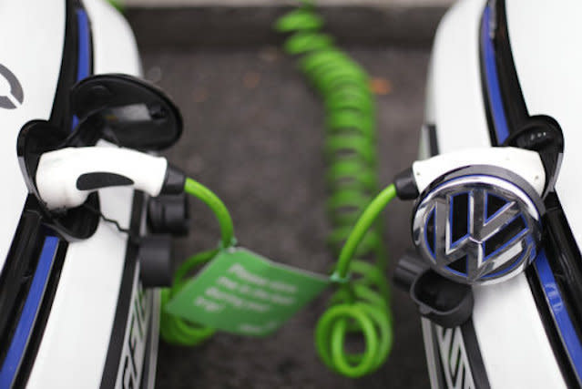 A pair of Zipcar club car-sharing Volkswagen Golf GTE plug-in petrol-electric hybrid cars being recharged on a street in central London.