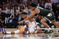 Kansas State forward David N'Guessan (3) and Michigan State guard A.J. Hoggard (11) reach for the loose ball in the first half of a Sweet 16 college basketball game in the East Regional of the NCAA tournament at Madison Square Garden, Thursday, March 23, 2023, in New York. (AP Photo/Adam Hunger)