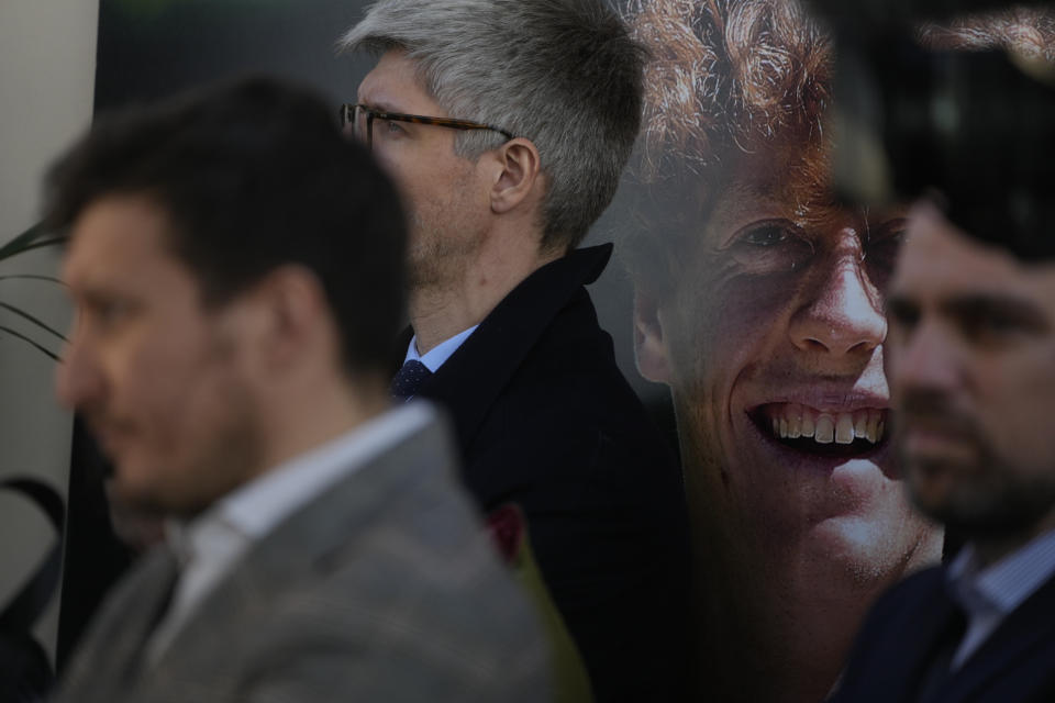 Journalists sit in front of a giant poster depicting Italian tennis player Jannik Sinner during a press conference in Rome, Wednesday, Jan. 31, 2024, after he won the Australian Open title on Sunday. Sinner, 22, was the the first Italian to win the Australian Open that is the first grand slam title of his career. (AP Photo/Gregorio Borgia)