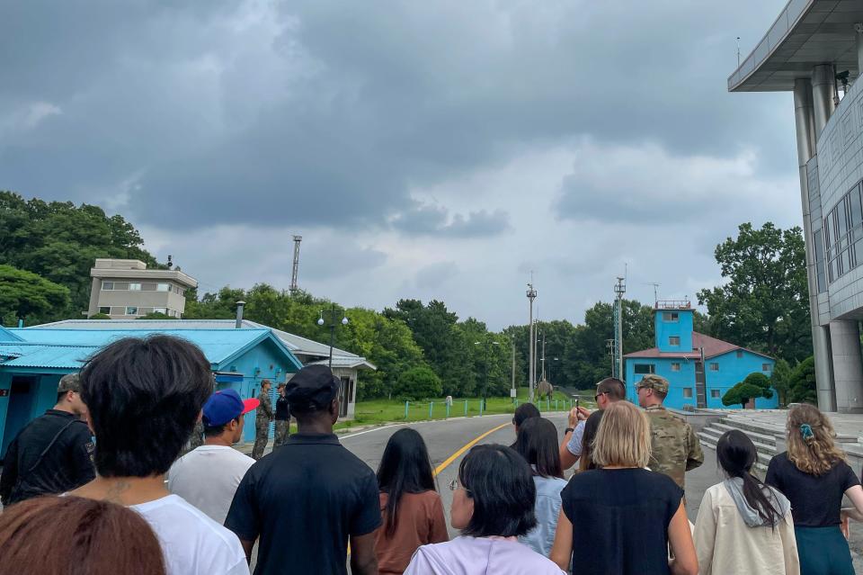 A group of tourists stand near a border station at Panmunjom in the Demilitarized Zone in Paju, South Korea on July 18. Not long after this photo was taken, Travis King, a U.S. soldier, bolted across the border and became the first known American detained in the North in nearly five years.